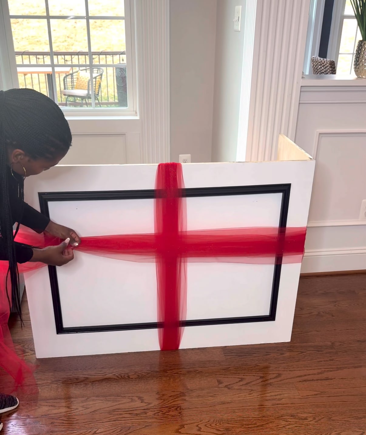 wrapping the red tulle around the diy mobile bar for decoration