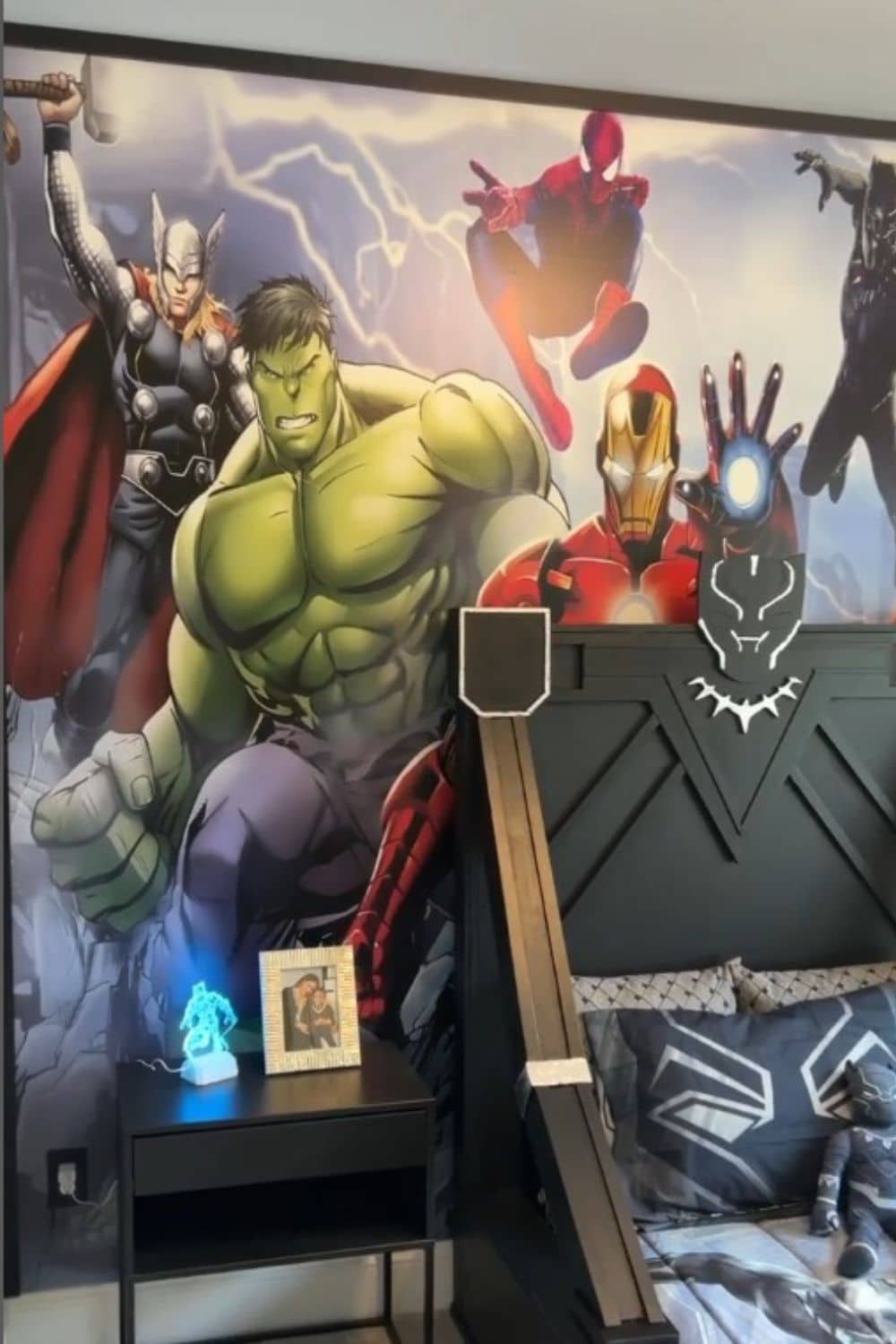 Avengers wallpaper mural behind Black Panther bed