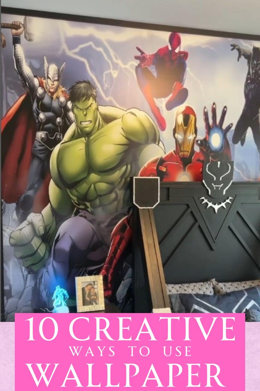 Superhero wallpaper behind a Black Panther bed.