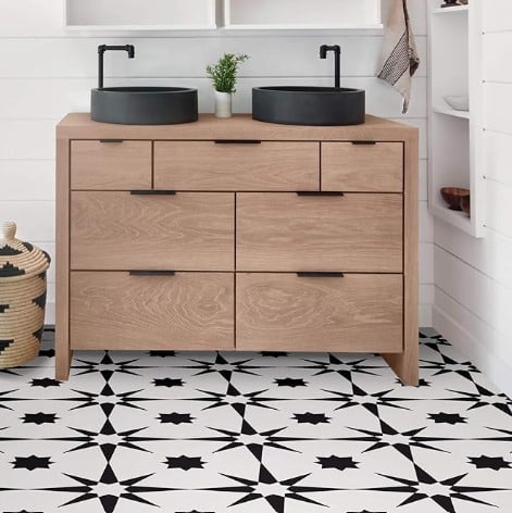 Image of a bathroom with starred black and white tile on the floor.