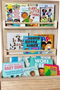 10 baby books on wooden shelves.