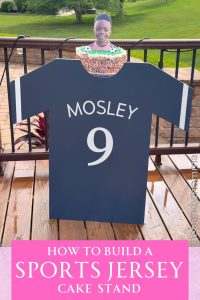 Sports jersey cake stand made out of wood, painted blue, and has the name Mosley and the number 9 on it.