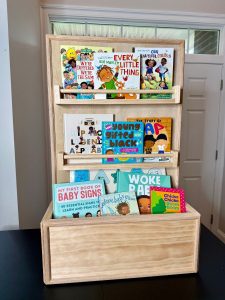 natural wood bookshelf filled with children's books.