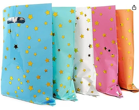 Multi colored goodie bags for a princess party with gold stars on them.
