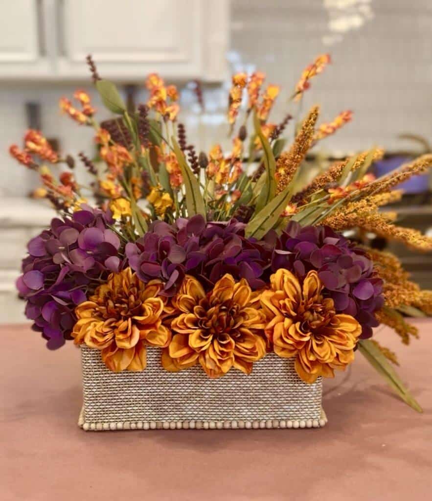 Fall flower arrangement in a grass cloth covered box that has beading around the edges.